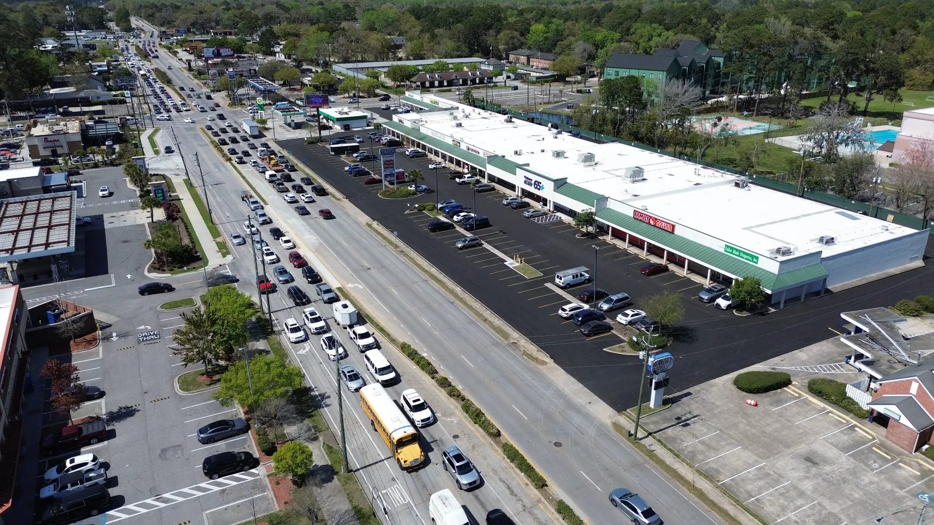 DeRenne Shopping Center aerial view showing full center, new asphalt, and Abercorn Street traffic